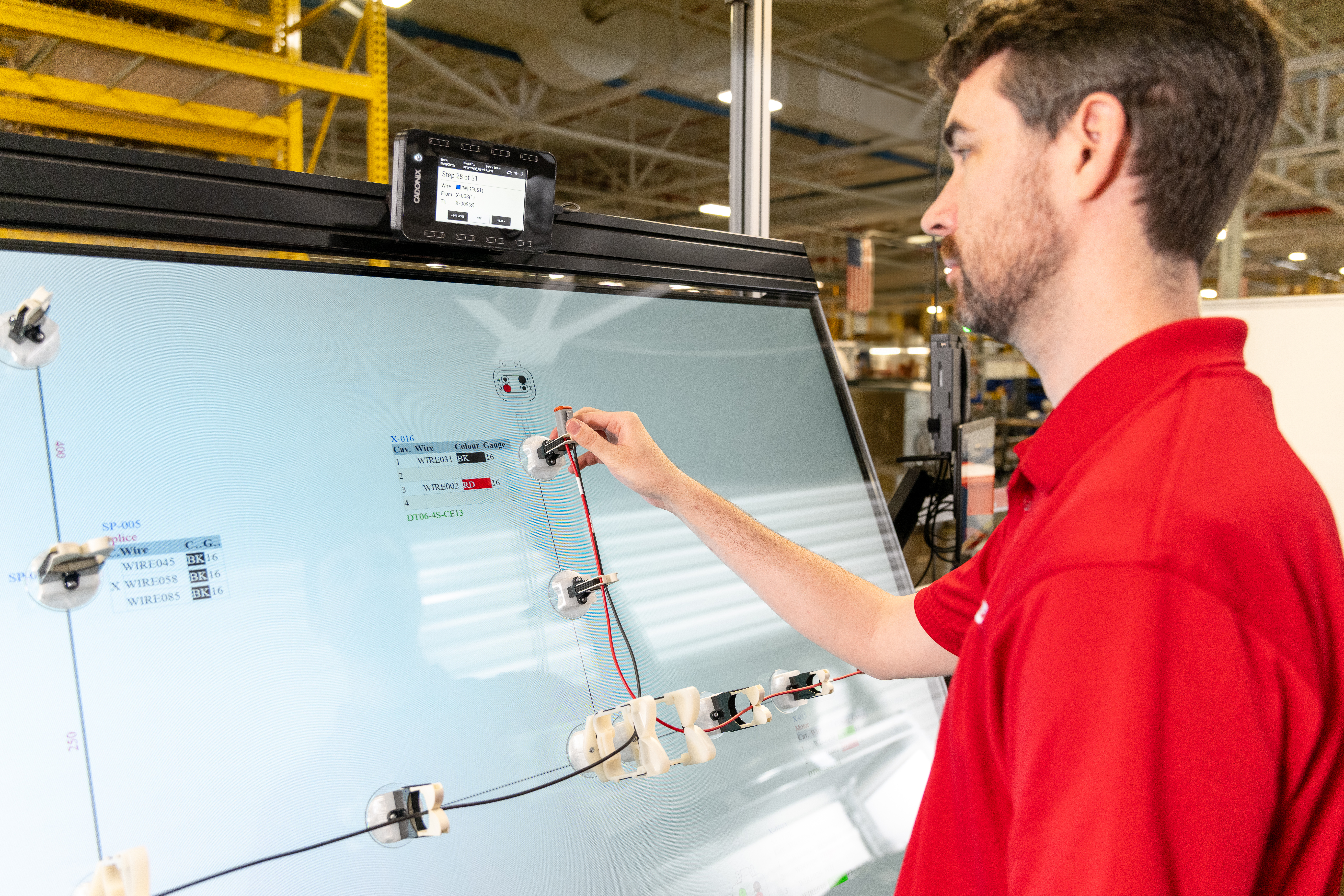 Visual guidance highlights each wire path, including splices and twisted pairs, while directing terminal placement into connectors and cavities, accelerating operator efficiency.