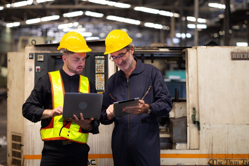 Two engineering man : Manufacture technical and factory staff working while Using digital tablet computer at industry factory Two engineering man : Manufacture technical and factory staff working while Using digital tablet computer at industry factory